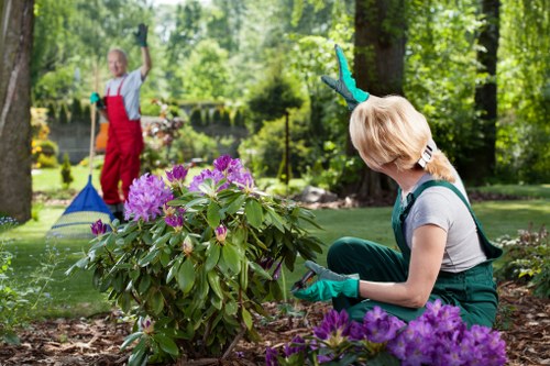 Worker wearing PPE operating gardening machinery responsibly