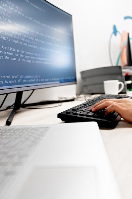 A close-up screenshot of a computer screen displaying HTML code for a website, including tags such as <!DOCTYPE html>, <html>, <head>, <title>, and <link>. The interface shows a dark background with c